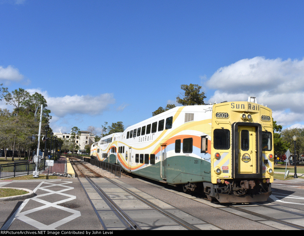 Bombardier Bilevel Cab Car # 2001 bringing up the back of Sunrail Train # P322 as it leaves WPK Station behind